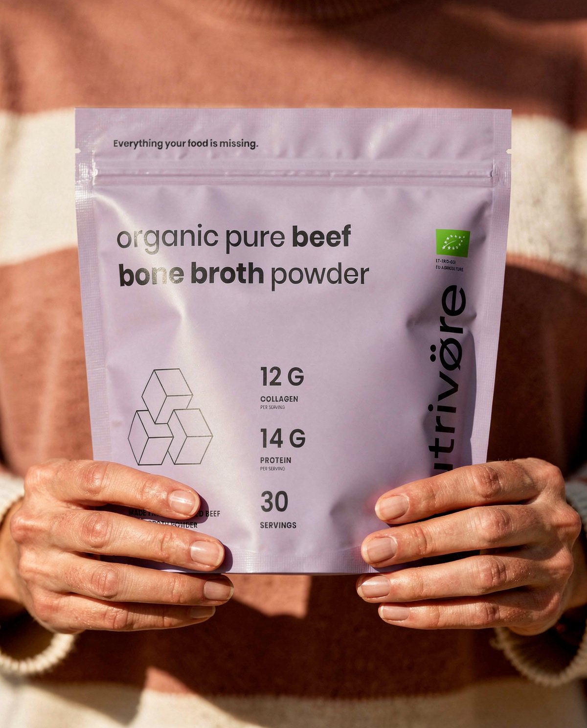 Nutriø̈tēca Organic Bone Broth Powder held in hand